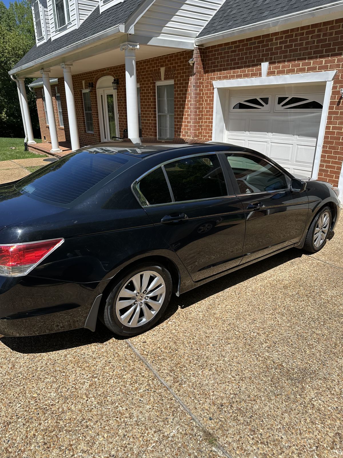 Black Honda Accord with glossy paint after exterior detailing